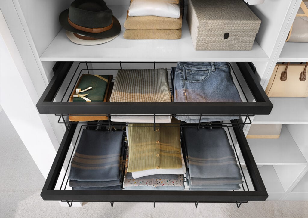 Organised wardrobe drawers with folded clothes and hats