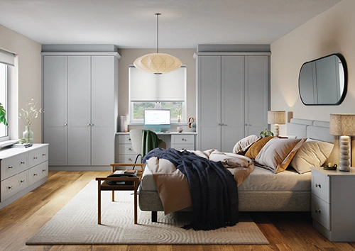 Modern grey bedroom with wardrobes and desk